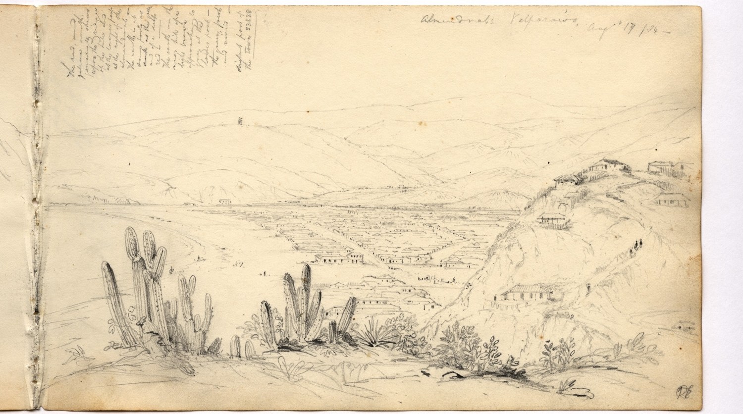 Ein aufgeschlagenes Buch, das eine Zeichnung einer Wüstenlandschaft mit Hügeln, Pflanzen und Text zeigt.