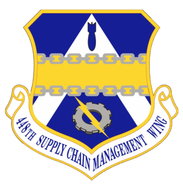 Logo des 48. Versorgungsgeschwader mit einem blauen Schild mit einem weißen Stern, einem weißen Banner mit der Aufschrift "Versorgungsmanagement" in Blau, alles umrandet von einem weißen Rand und begleitet von dem Text "48. Versorgungsgeschwader" in fetter schwarzer Schrift.